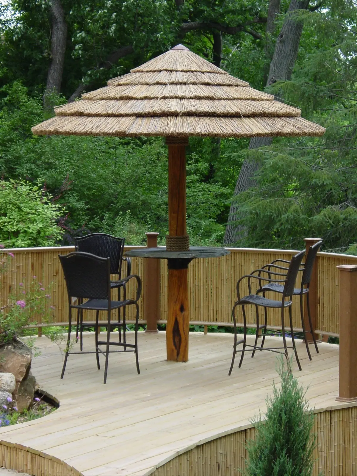 bamboo panels combined with seating around african thatch umbrella