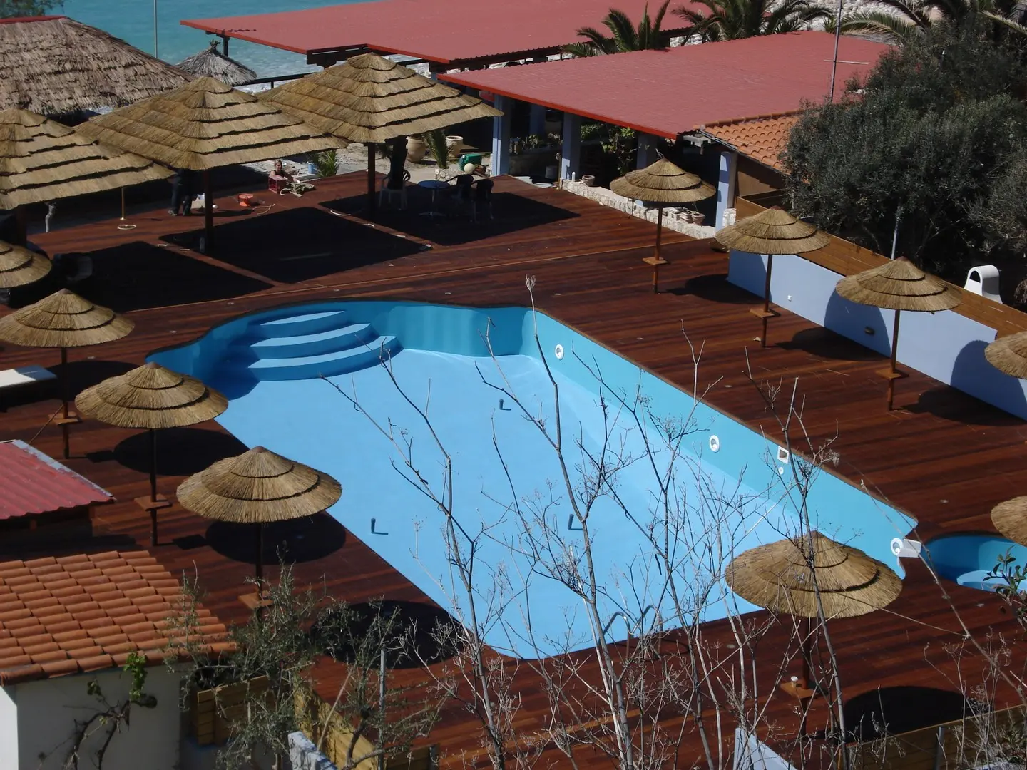 cape reed umbrellas around a pool